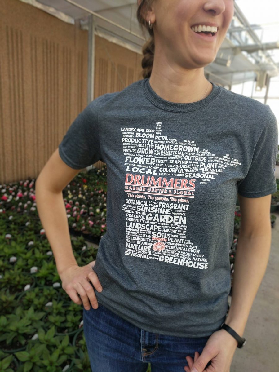 woman with hand on hip wearing grey tshirt with the state of minnesota printed with various gardening words.