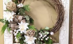 seasonal wreath with white mums, evergreens and bows